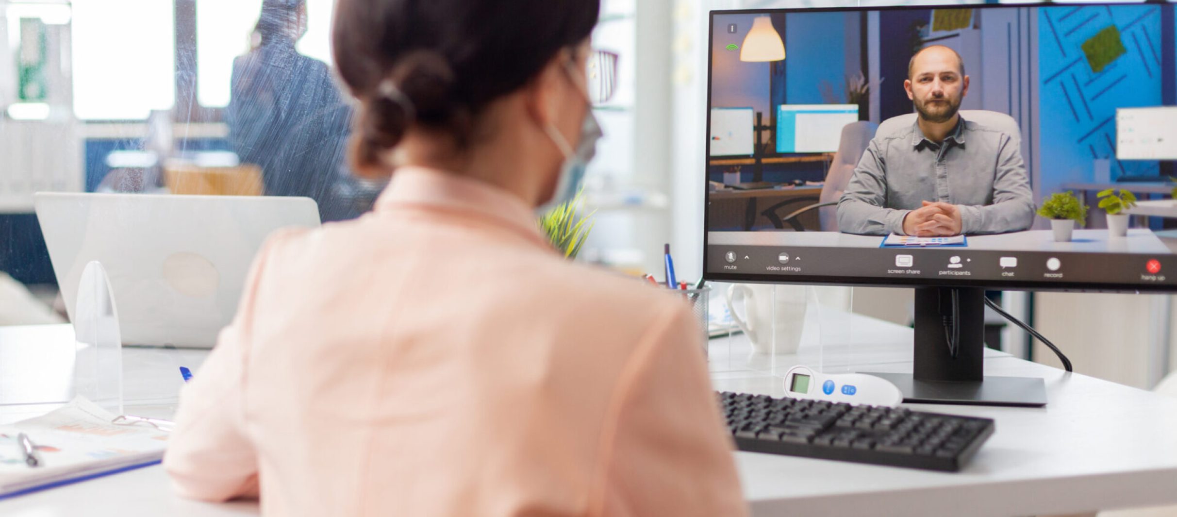 Woman in new normal office listening man talking