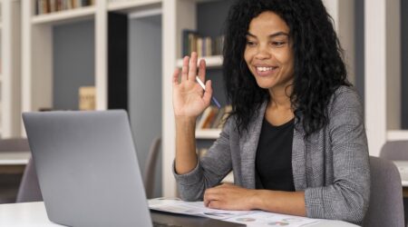 medium-shot-woman-waving-at-laptop